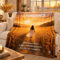 Abundance motivational quote blanket draped over a sofa